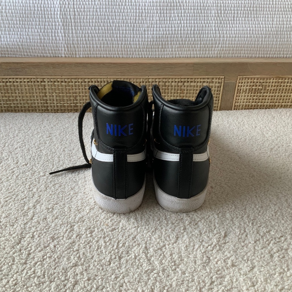 Nike Black and white leather high tops with blue Nike logo